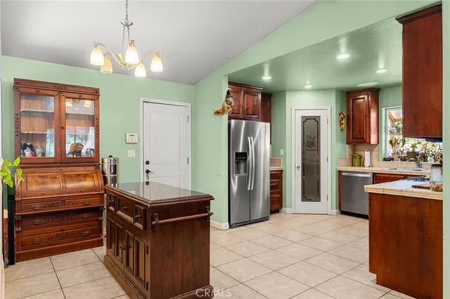 a kitchen with refrigerator cabinets and wooden floor