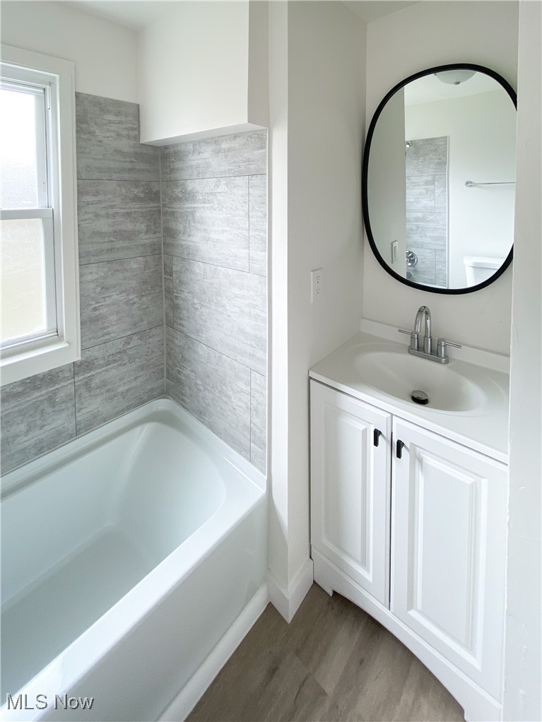 14628 Granger Road Maple Heights, OH 44137 - Photo 11 of 45 Bathroom with hardwood / wood-style flooring and vanity
