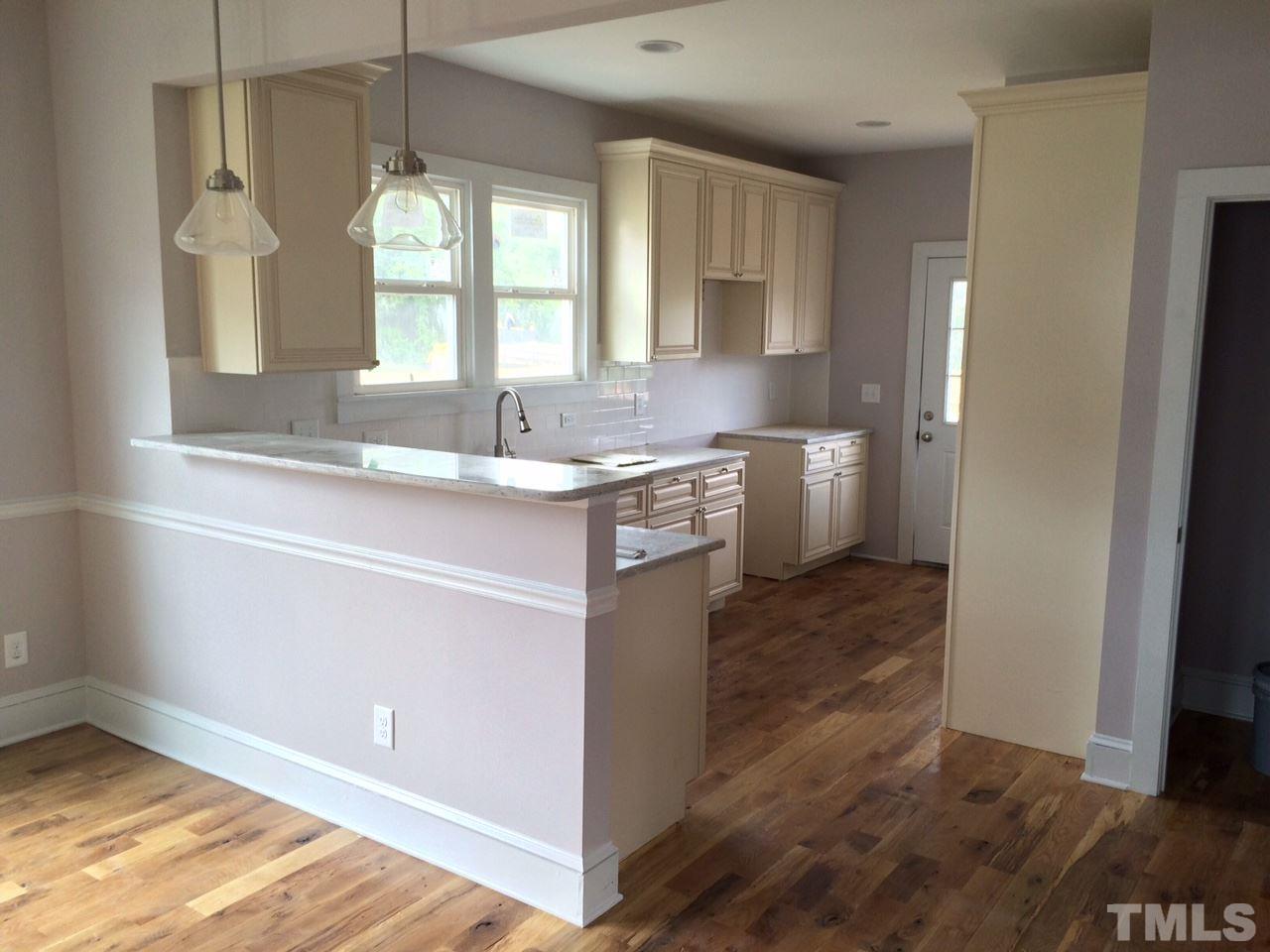 401 Bledsoe Avenue Raleigh, NC 27601 - Photo 3 of 5 a kitchen with a sink cabinets and wooden floor