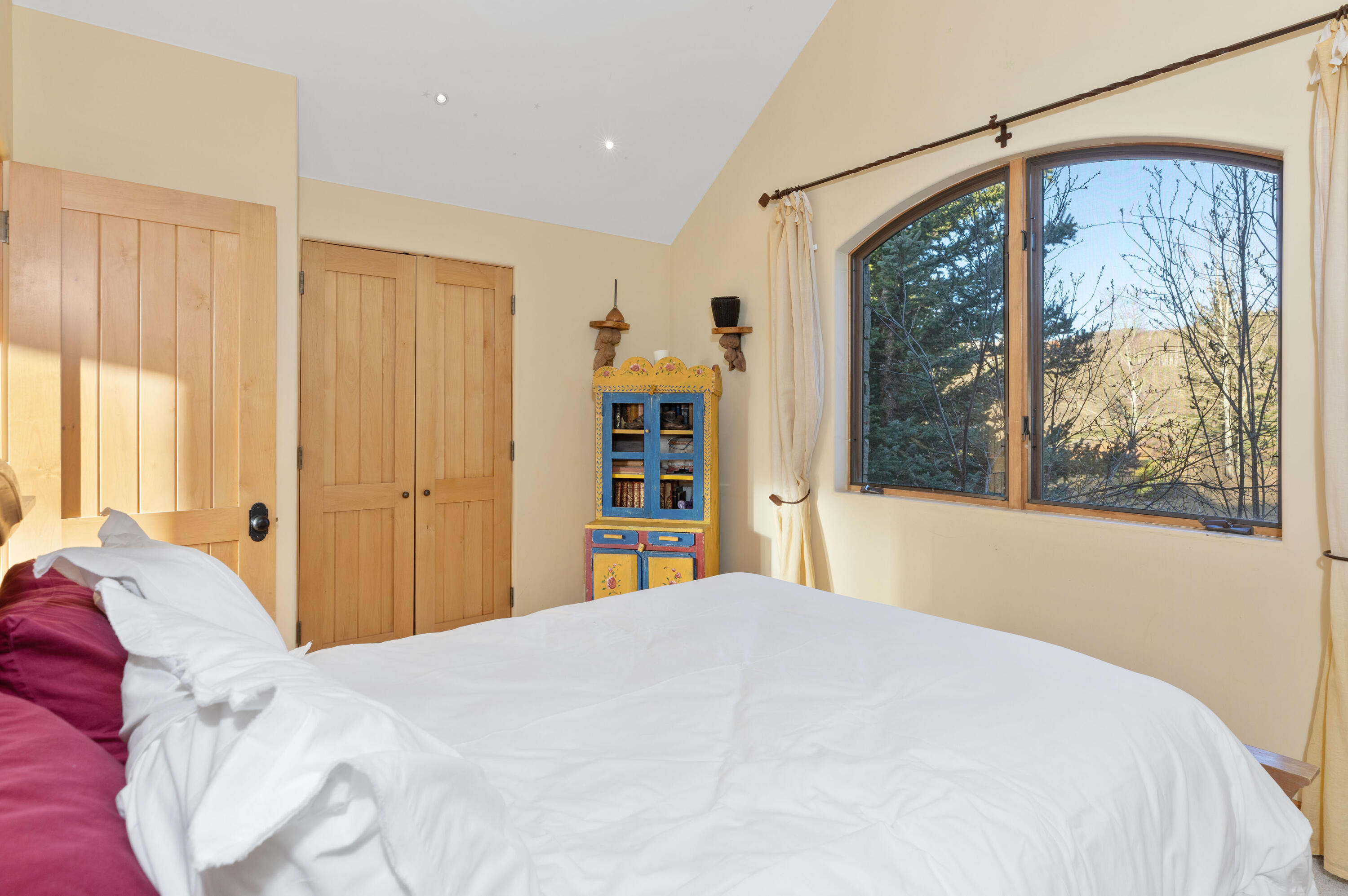 151 Adams Ranch Road Mountain Village, CO 81435 - Photo 25 of 38 a bedroom with a large bed and a window