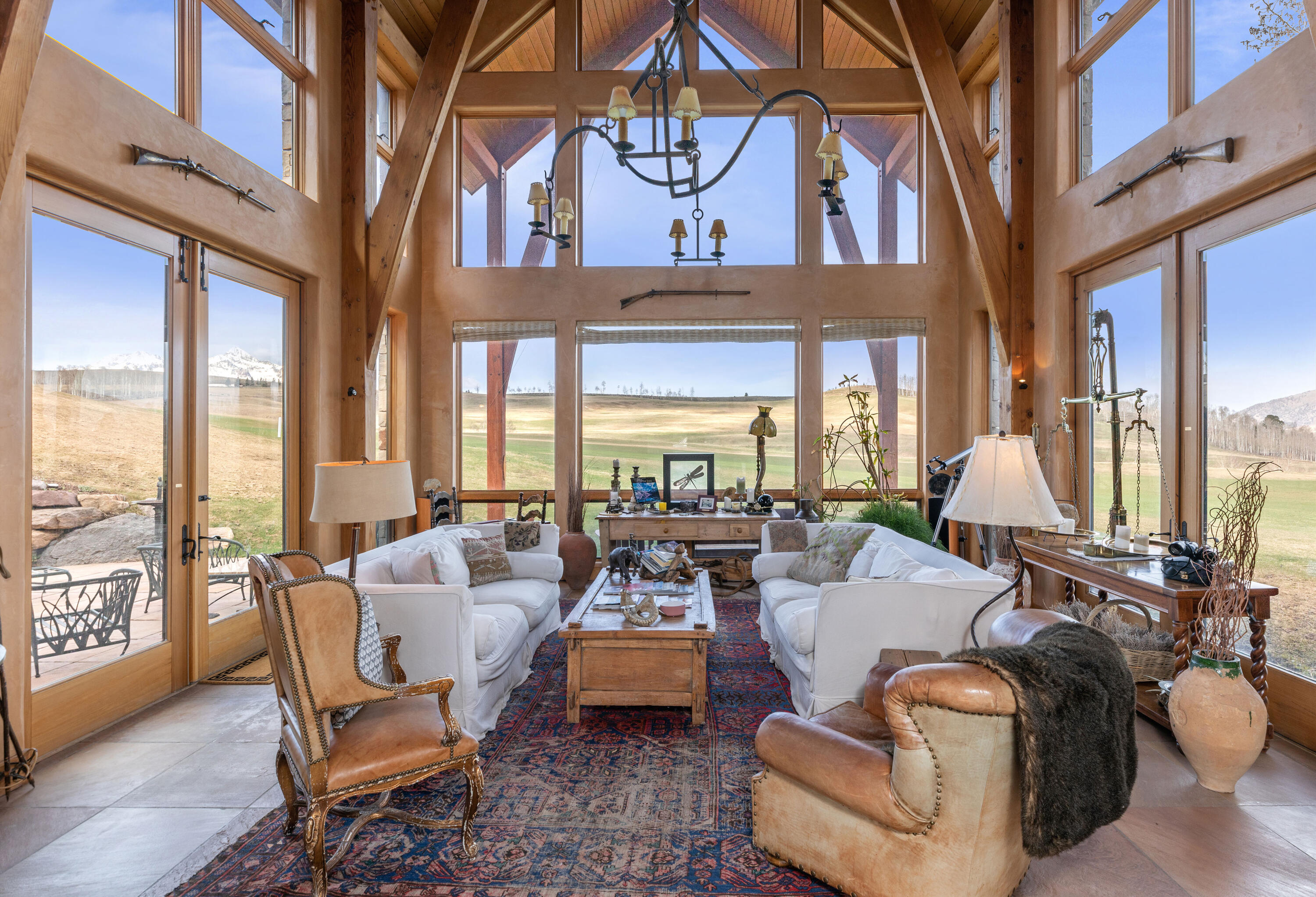 151 Adams Ranch Road Mountain Village, CO 81435 - Photo 8 of 38 a living room with furniture and floor to ceiling windows