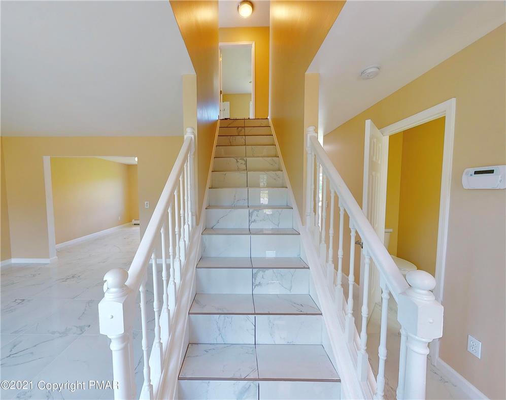 1110 Misty Ridge East Stroudsburg, PA 18302 - Photo 20 of 43 A grand staircase with elegant tile flooring welcomes you into this inviting home.