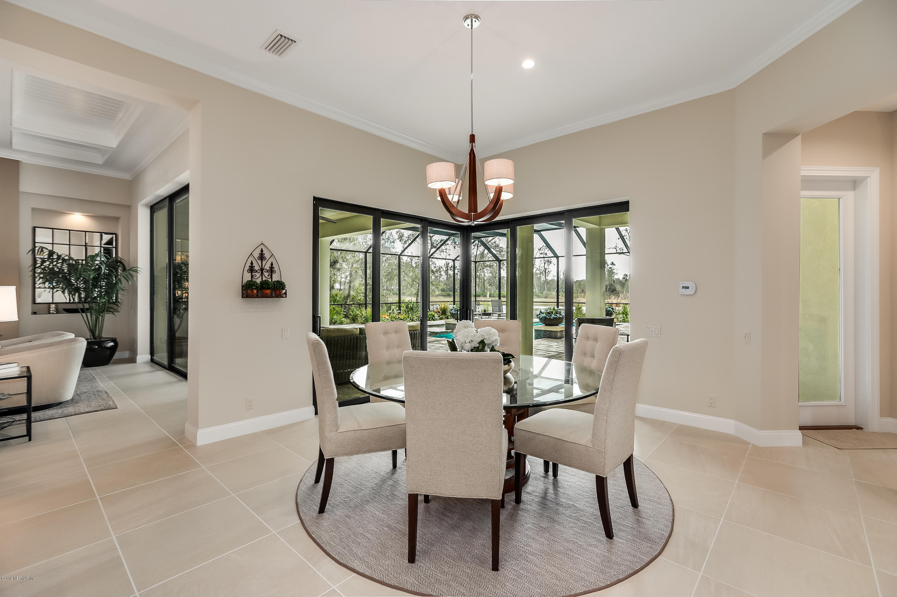 68 Costa Del Sol Drive St. Augustine, FL 32095 - Photo 12 of 55 a dining room with furniture a chandelier and wooden floor