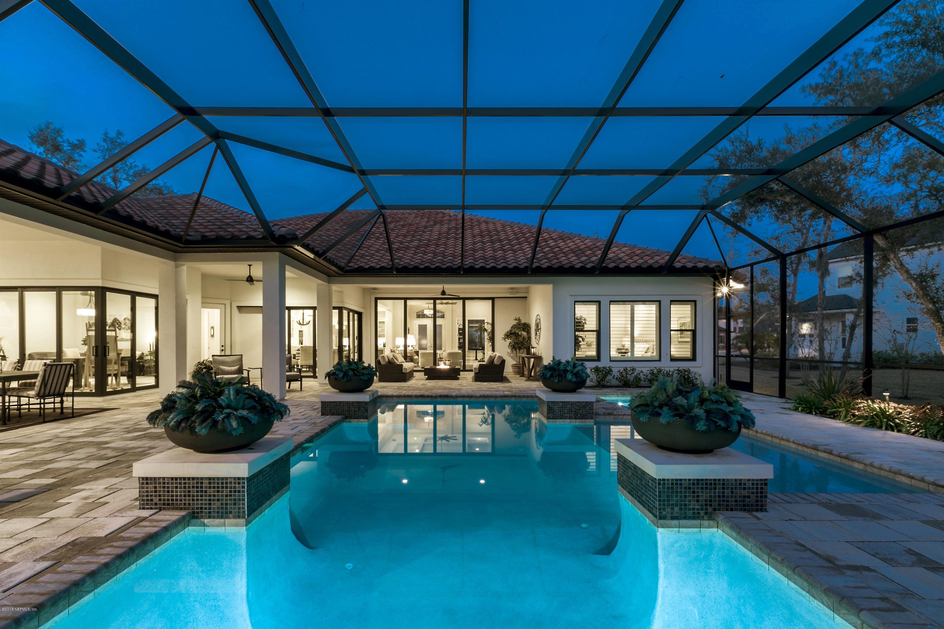 68 Costa Del Sol Drive St. Augustine, FL 32095 - Photo 14 of 55 a living room with furniture a chandelier a rug and a window