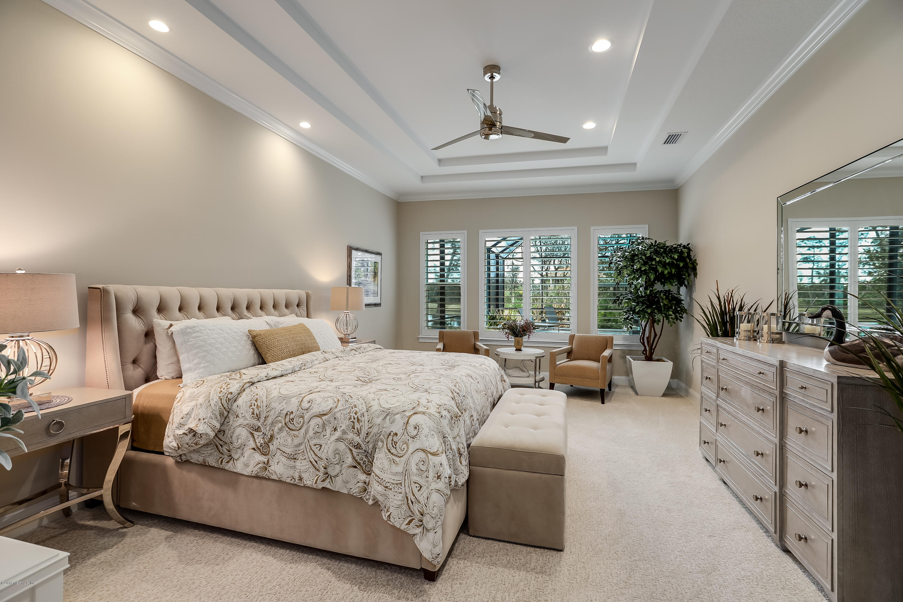 68 Costa Del Sol Drive St. Augustine, FL 32095 - Photo 18 of 55 a spacious bedroom with a large bed and a chandelier