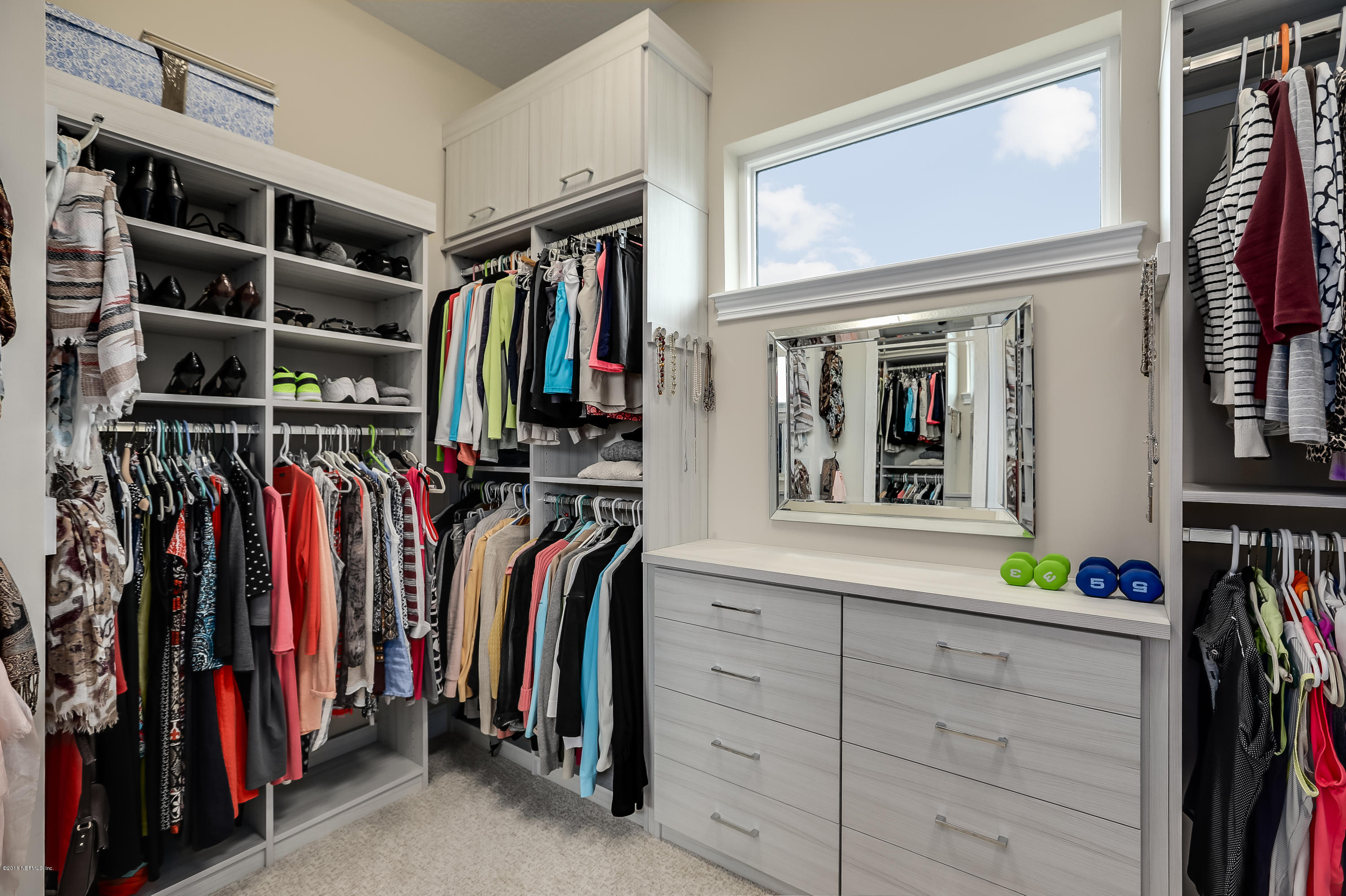 68 Costa Del Sol Drive St. Augustine, FL 32095 - Photo 19 of 55 a view of walk in closet with clothes and shoes
