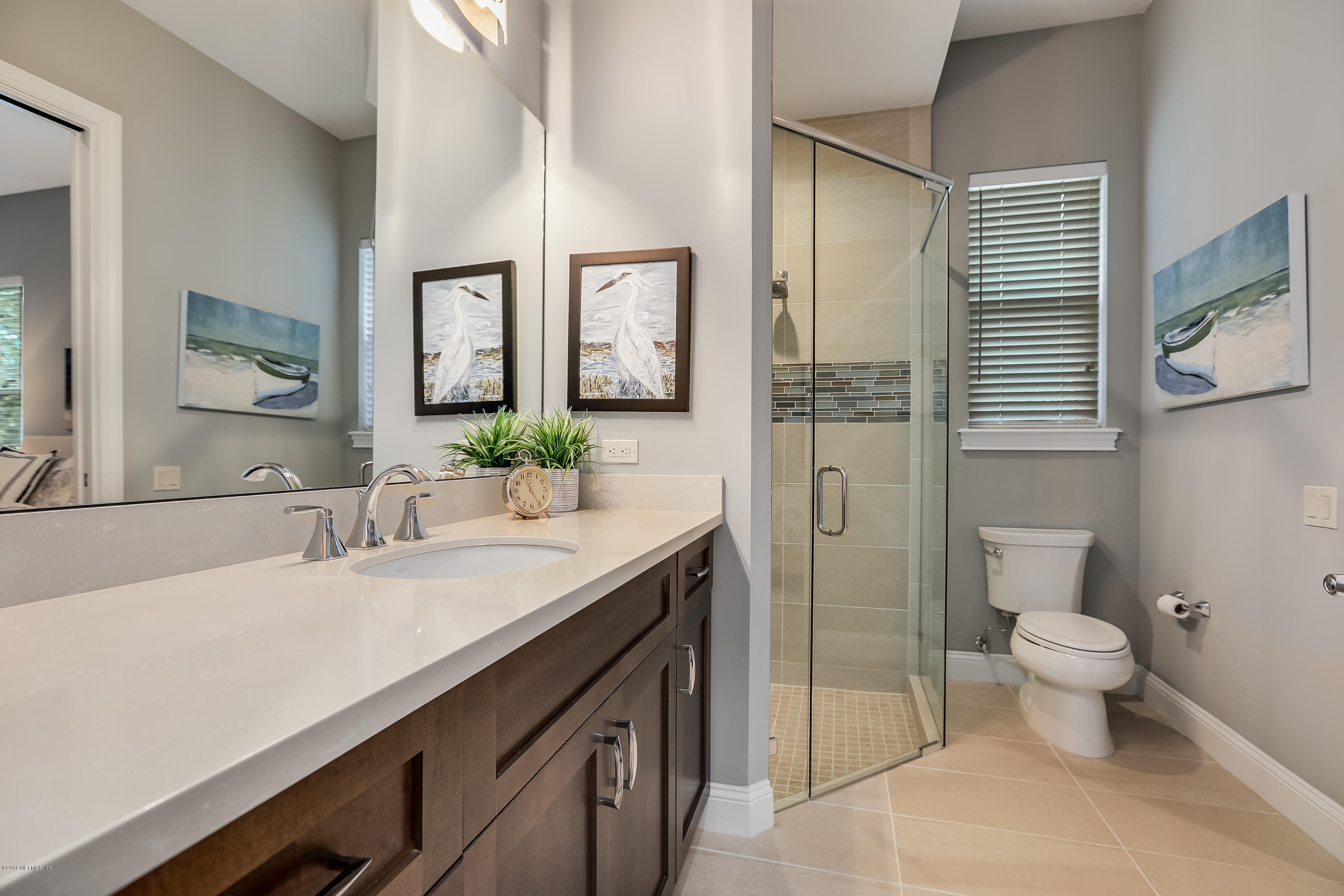 68 Costa Del Sol Drive St. Augustine, FL 32095 - Photo 27 of 55 a bathroom with a granite countertop sink a toilet a mirror and shower