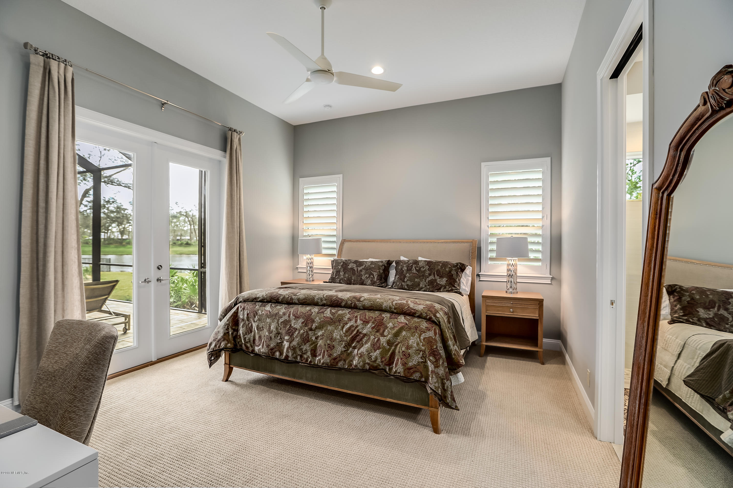 68 Costa Del Sol Drive St. Augustine, FL 32095 - Photo 28 of 55 a bedroom with a bed couch and a window