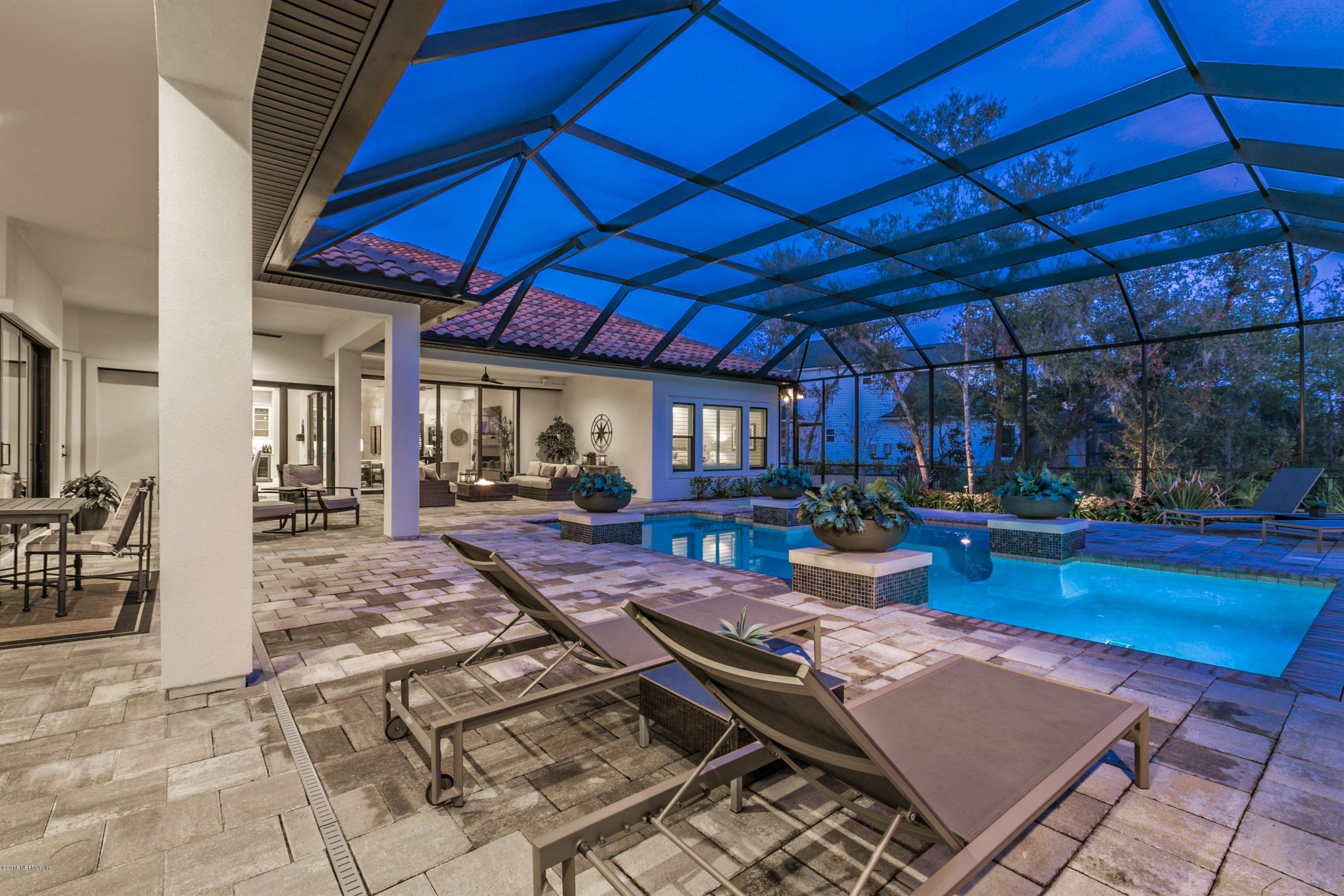 68 Costa Del Sol Drive St. Augustine, FL 32095 - Photo 33 of 55 a view of a backyard with table and chairs under an umbrella