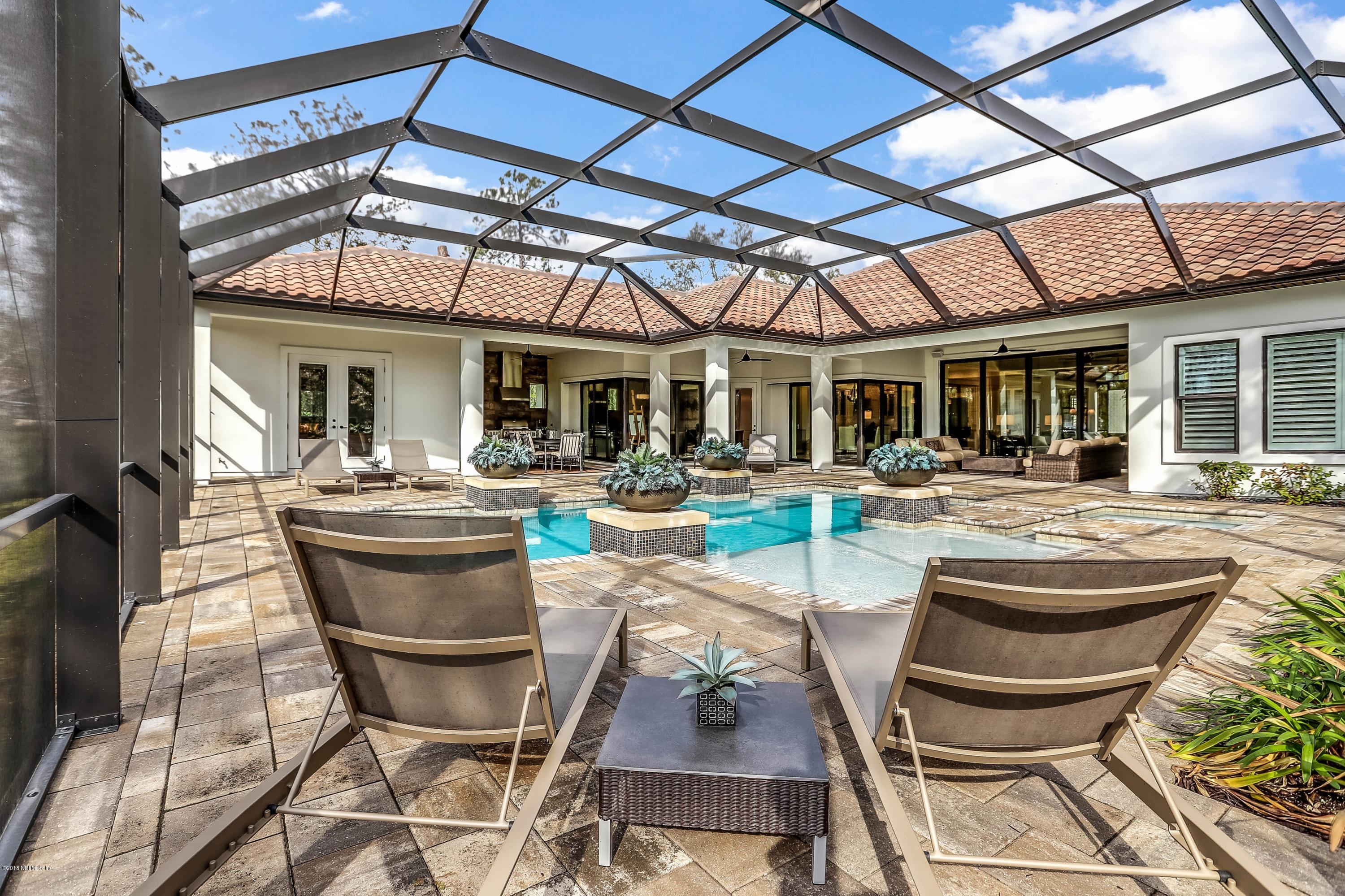 68 Costa Del Sol Drive St. Augustine, FL 32095 - Photo 34 of 55 a view of a patio with table and chairs potted plants and floor to ceiling window