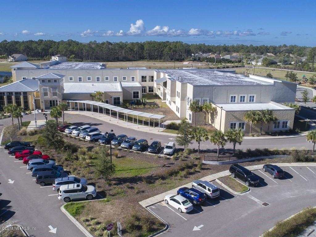 68 Costa Del Sol Drive St. Augustine, FL 32095 - Photo 44 of 55 a view of a city with lots of residential buildings and cars park on the roadside