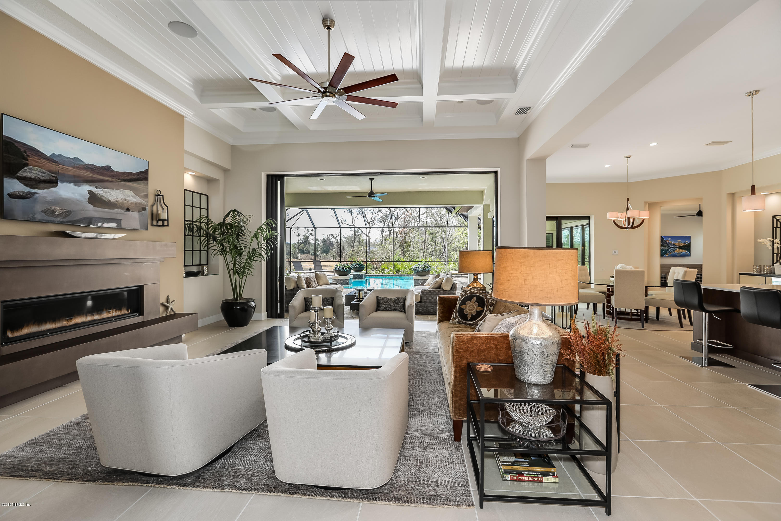 68 Costa Del Sol Drive St. Augustine, FL 32095 - Photo 5 of 55 a living room with furniture a chandelier and a large window