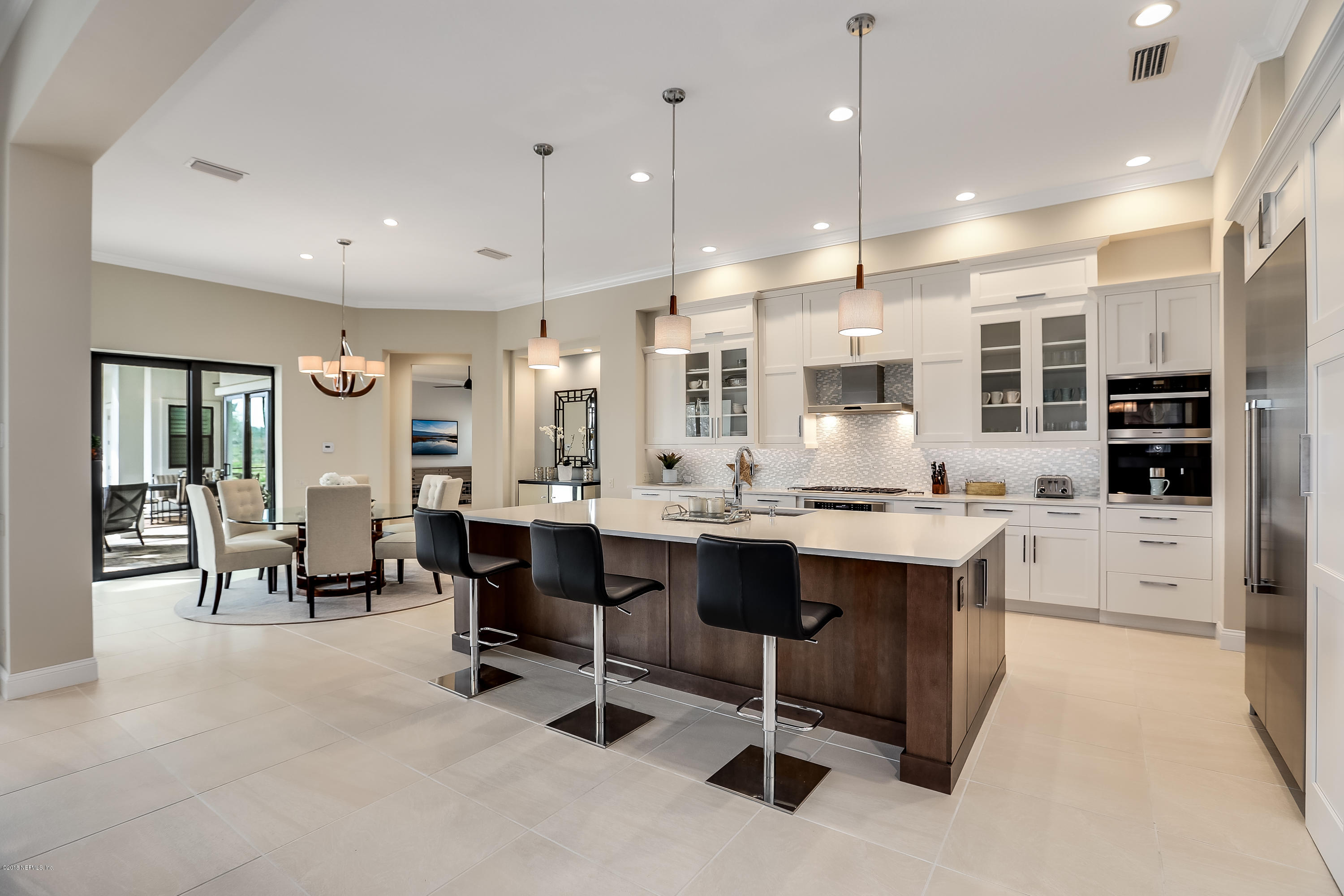 68 Costa Del Sol Drive St. Augustine, FL 32095 - Photo 7 of 55 a large dining hall with stainless steel appliances kitchen island granite countertop furniture and a view of living room