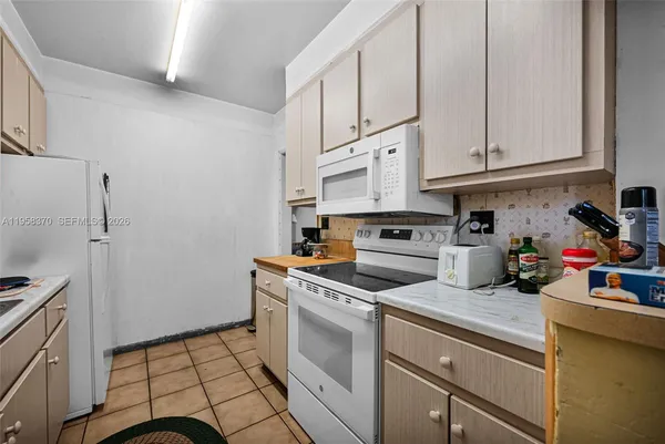 a kitchen with stainless steel appliances a refrigerator sink and cabinets
