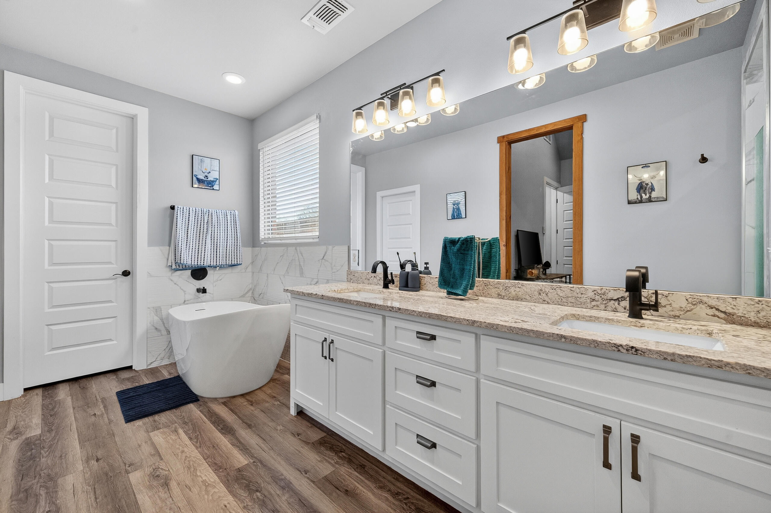 11211 Grover Avenue Lubbock, TX 79424 - Photo 19 of 43 a spacious bathroom with a granite countertop sink mirror and bathtub