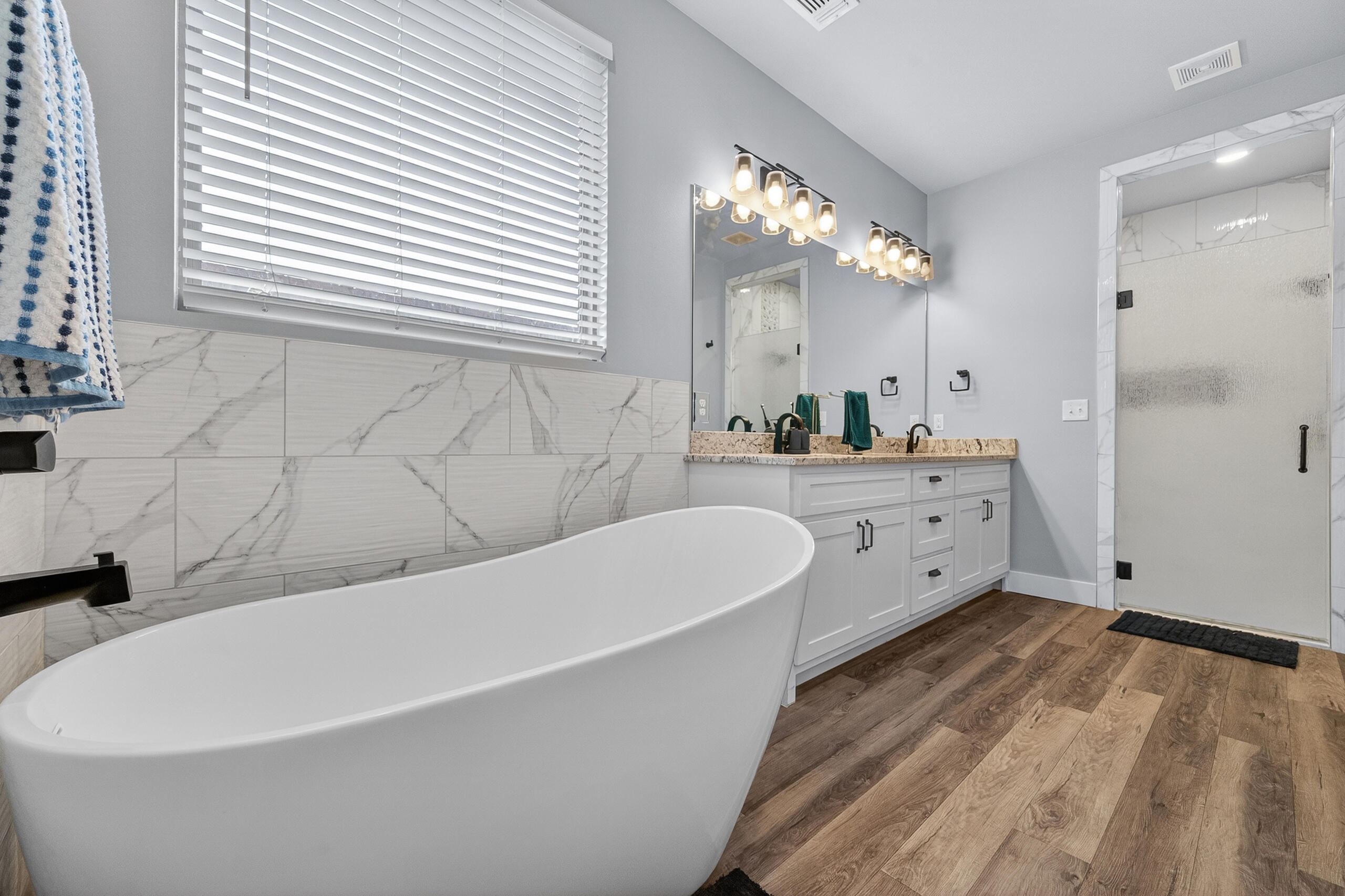 11211 Grover Avenue Lubbock, TX 79424 - Photo 20 of 43 a white bath tub sitting in a bathroom