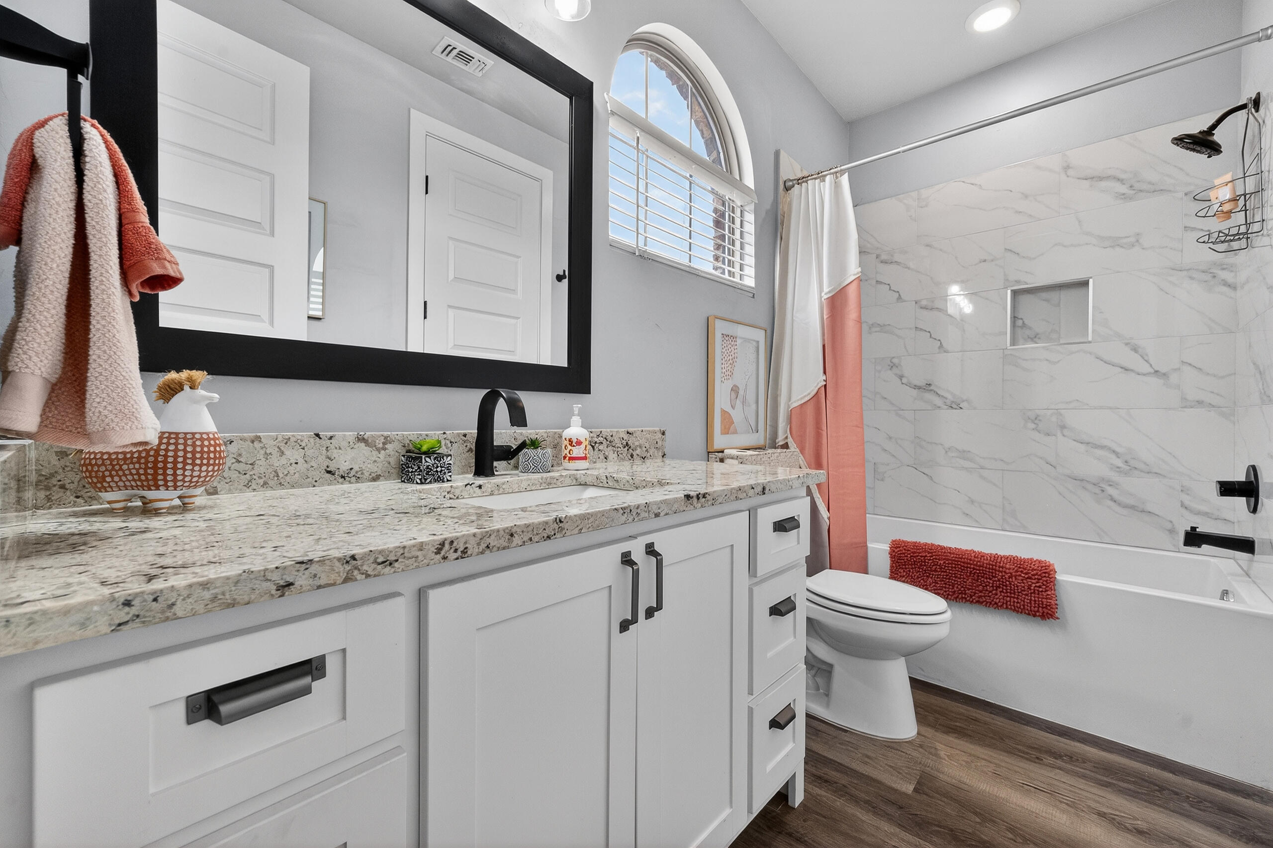 11211 Grover Avenue Lubbock, TX 79424 - Photo 25 of 43 a bathroom with a granite countertop sink a toilet and a bathtub