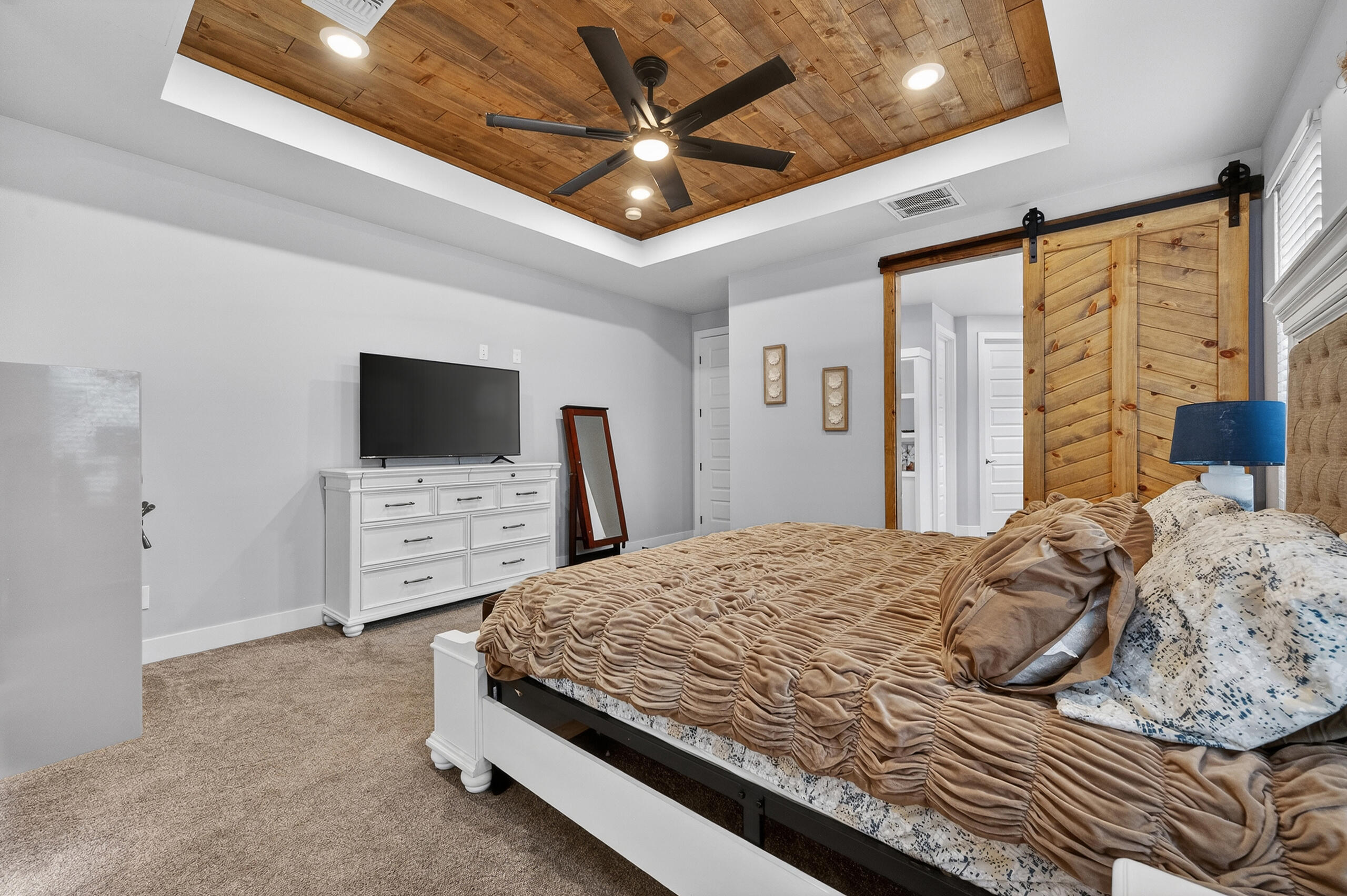 11211 Grover Avenue Lubbock, TX 79424 - Photo 28 of 43 a bedroom with a bed and a flat screen tv