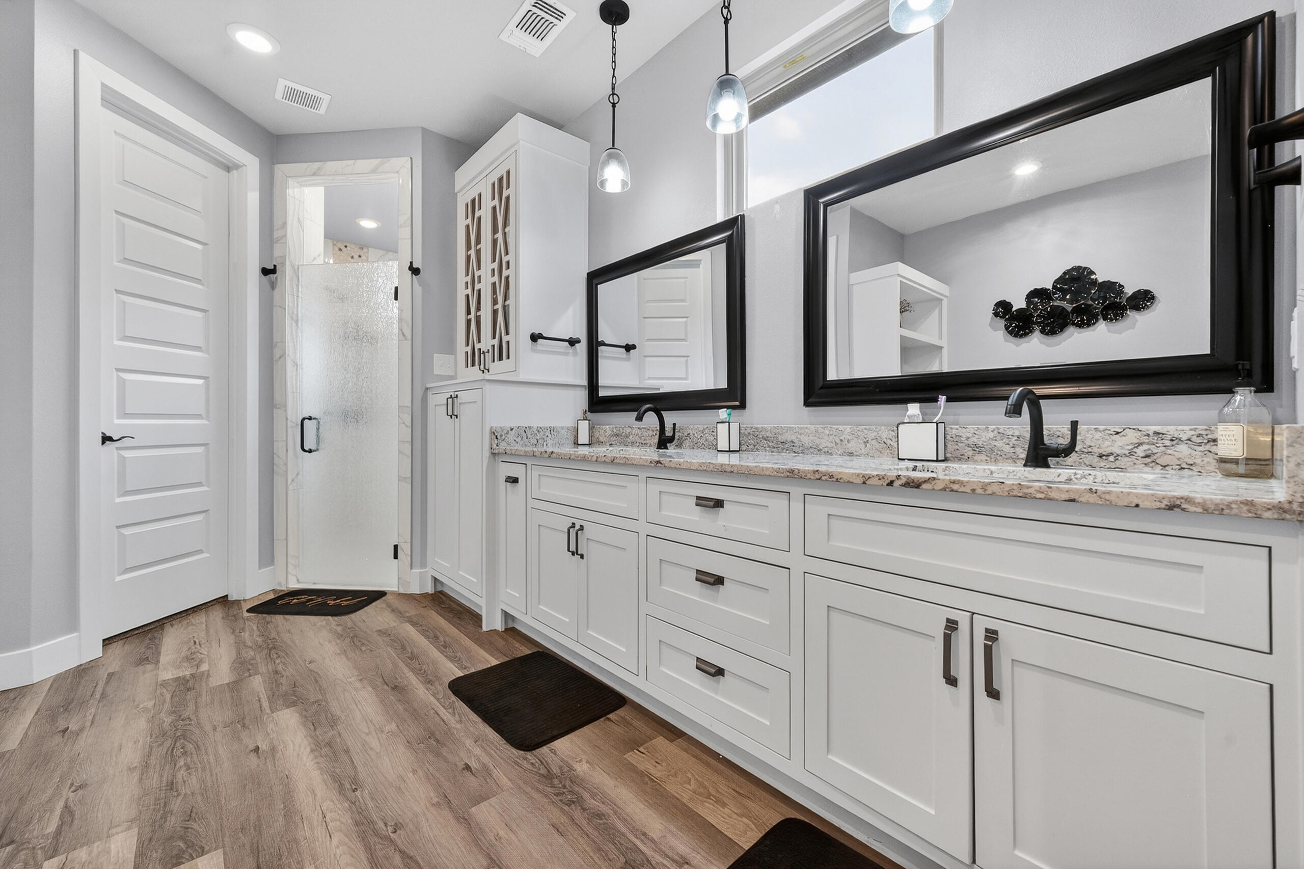 11211 Grover Avenue Lubbock, TX 79424 - Photo 29 of 43 a bathroom with double vanity sink and a mirror