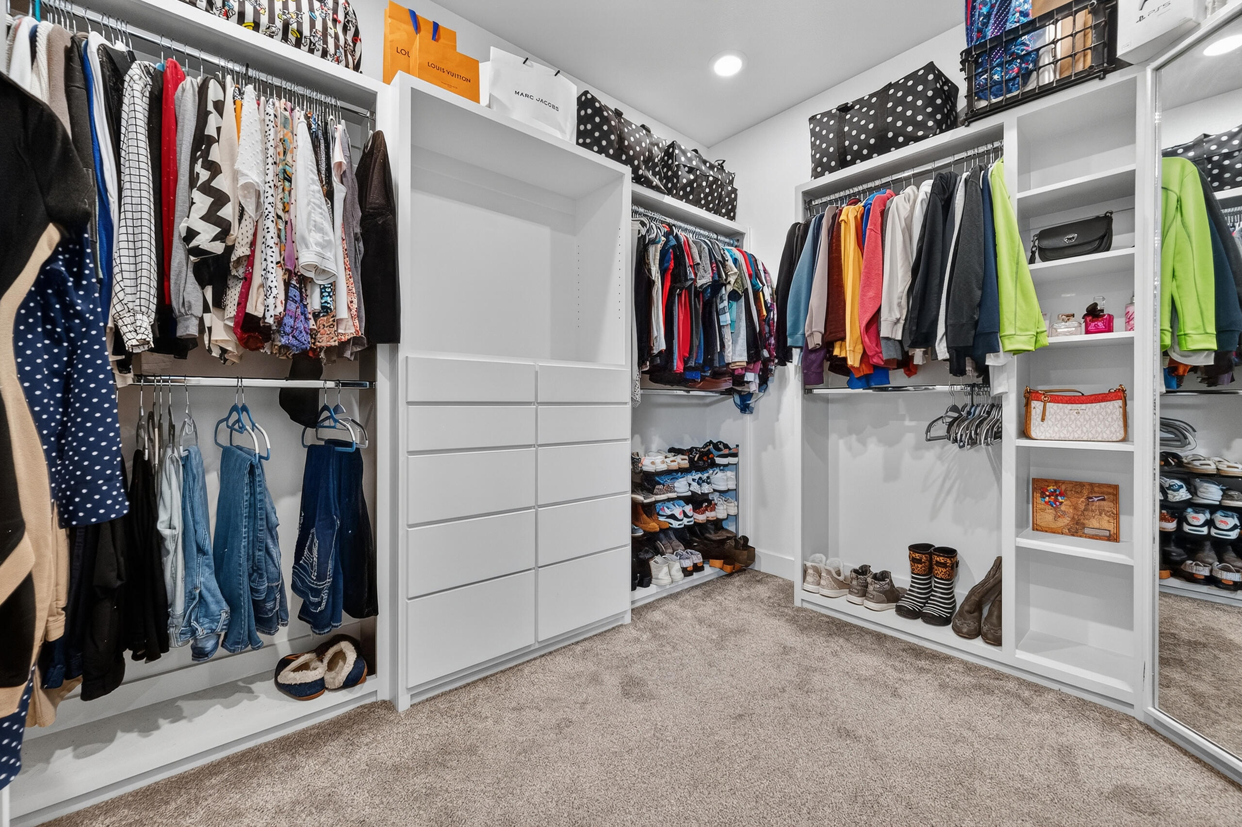 11211 Grover Avenue Lubbock, TX 79424 - Photo 35 of 43 a view of walk in closet with clothes and shoes