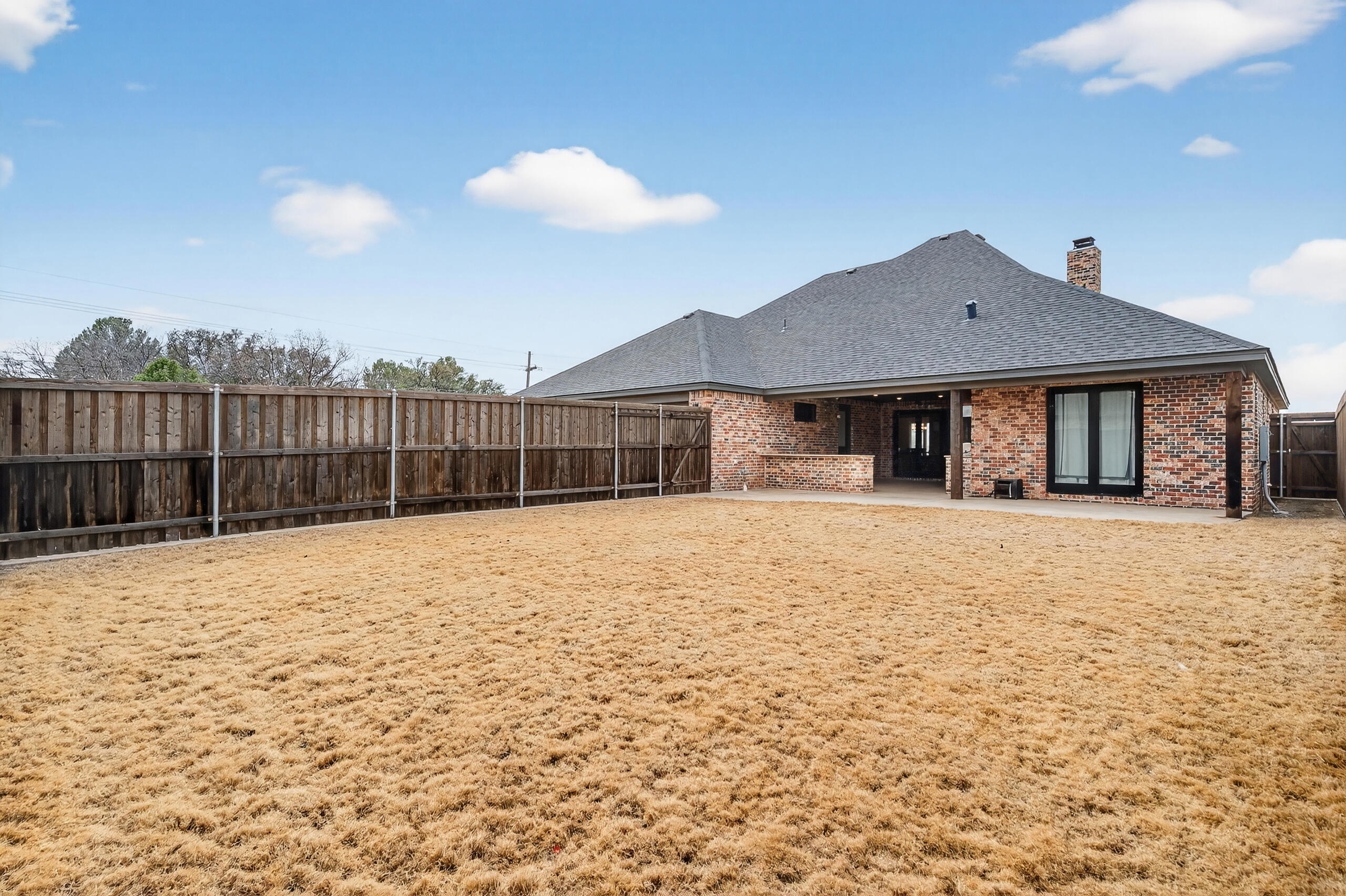 11211 Grover Avenue Lubbock, TX 79424 - Photo 43 of 43 a view of a house with a yard and sitting area