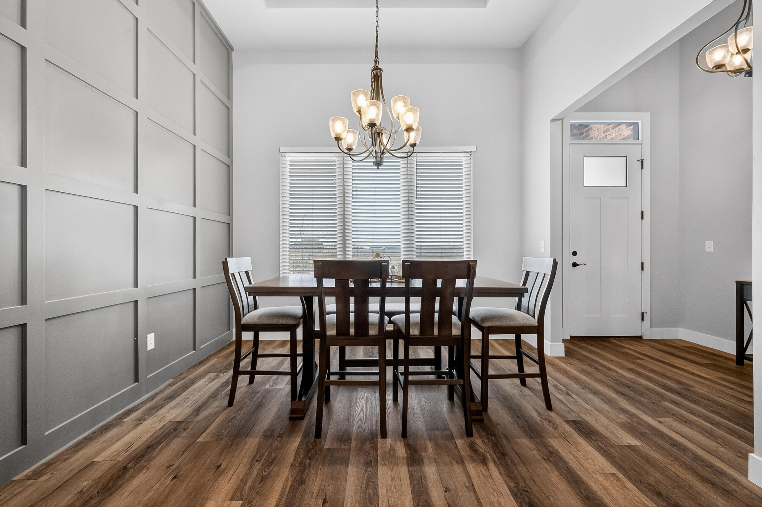 11211 Grover Avenue Lubbock, TX 79424 - Photo 7 of 43 a view of a dining room with furniture wooden floor and chandelier