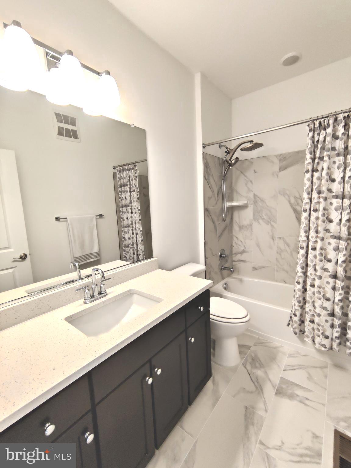 5002 Longmire Way, Unit 70 Chantilly, VA 20151 - Photo 12 of 28 a bathroom with a sink a toilet and shower