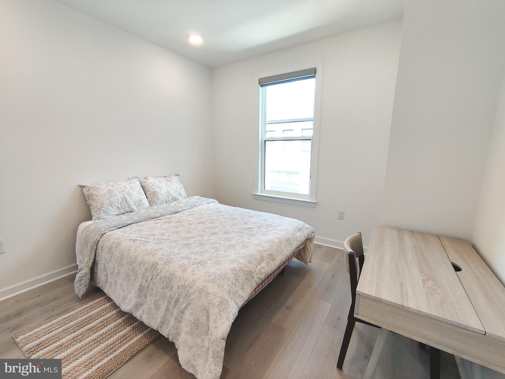 5002 Longmire Way, Unit 70 Chantilly, VA 20151 - Photo 13 of 28 a bed sitting in a bedroom next to a window