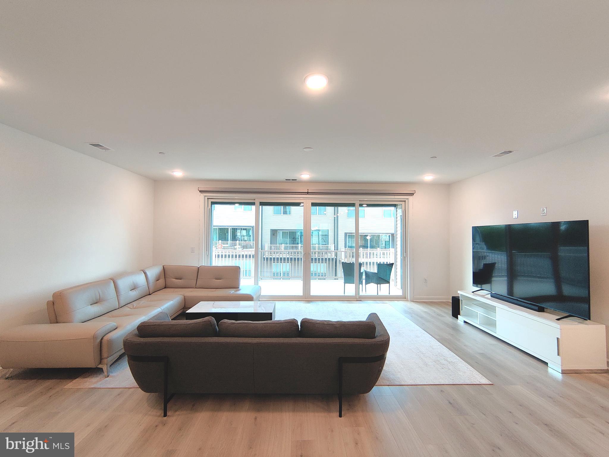 5002 Longmire Way, Unit 70 Chantilly, VA 20151 - Photo 2 of 28 a living room with furniture and a flat screen tv
