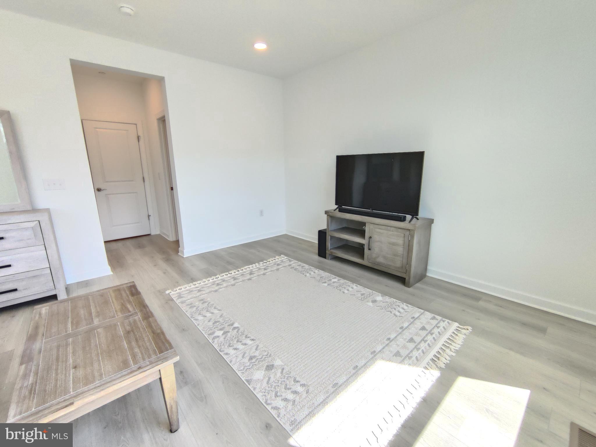 5002 Longmire Way, Unit 70 Chantilly, VA 20151 - Photo 22 of 28 a bedroom with a bed and flat screen tv