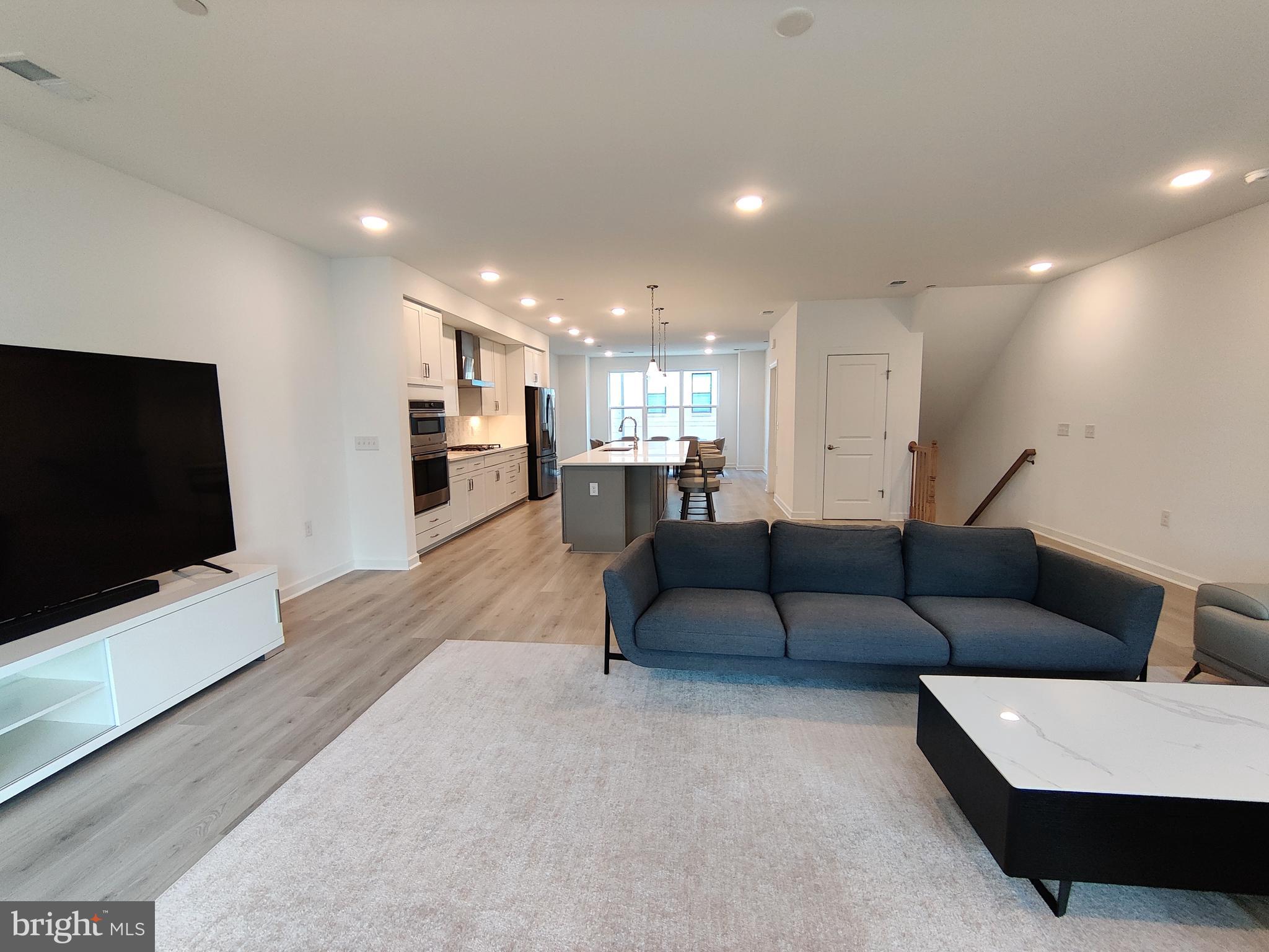 5002 Longmire Way, Unit 70 Chantilly, VA 20151 - Photo 4 of 28 a living room with furniture and a flat screen tv