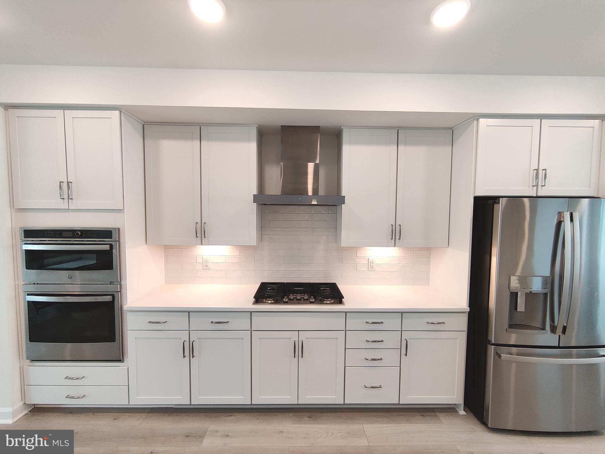 5002 Longmire Way, Unit 70 Chantilly, VA 20151 - Photo 7 of 28 a kitchen with granite countertop white cabinets and stainless steel appliances