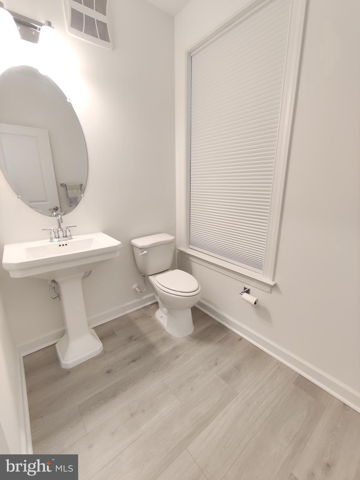 5002 Longmire Way, Unit 70 Chantilly, VA 20151 - Photo 10 of 28 a white toilet sitting next to a bathroom sink