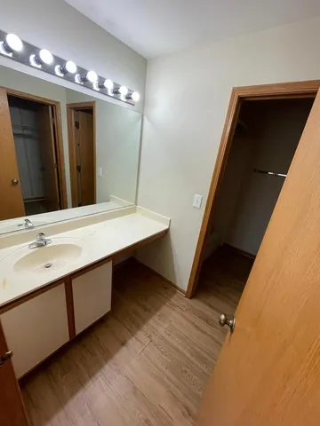 a bathroom with a double vanity sink and a mirror