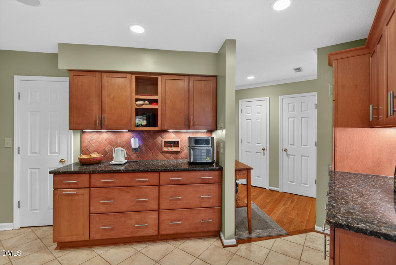 3307 Coachman's Way Durham, NC 27705 - Photo 8 of 50 a kitchen with stainless steel appliances granite countertop a refrigerator and a sink