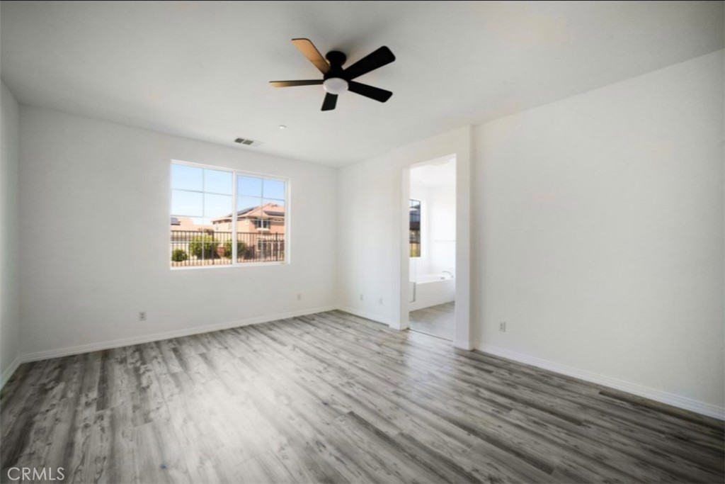 30237 Bristol Gate Lane Menifee, CA 92584 - Photo 13 of 34 wooden floor in an empty room with a window