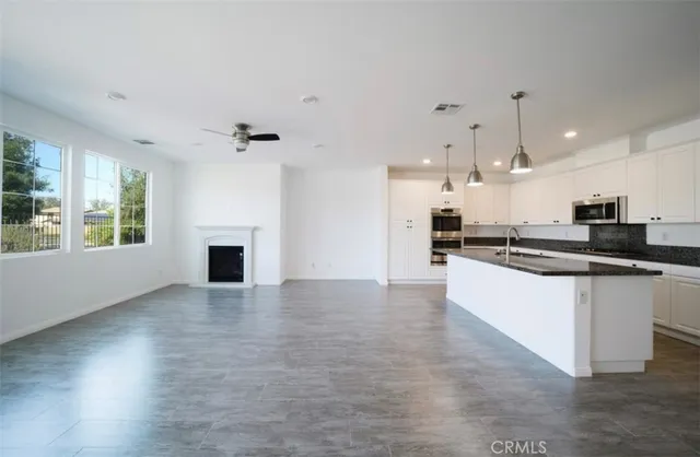 a view of kitchen with refrigerator and window