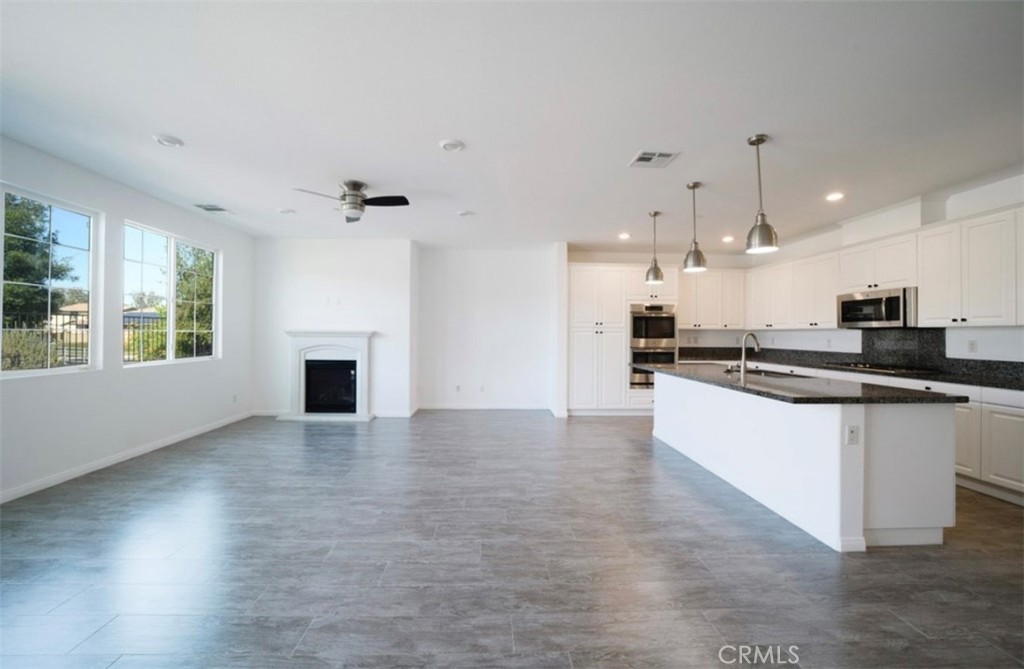 30237 Bristol Gate Lane Menifee, CA 92584 - Photo 19 of 34 a view of kitchen with refrigerator and window