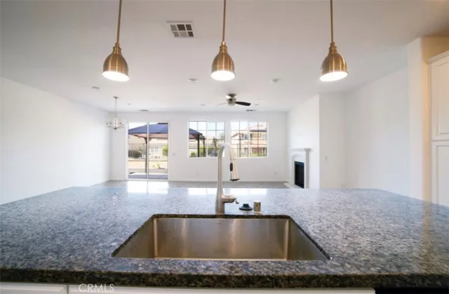 a view of a kitchen with kitchen island a sink wooden floor and window