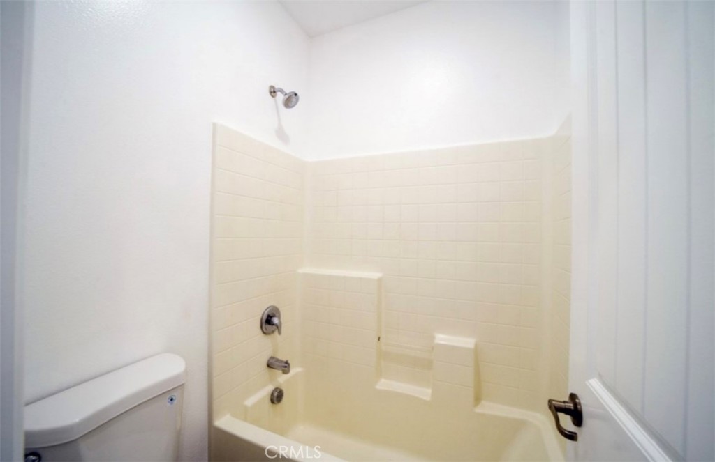 30237 Bristol Gate Lane Menifee, CA 92584 - Photo 7 of 34 a bathroom with a bathtub