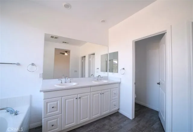a bathroom with a double vanity sink and mirror