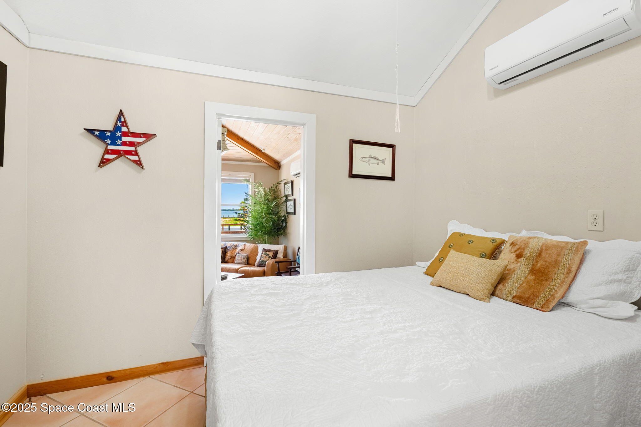 36 Vip Island, Unit A Grant, FL 32949 - Photo 14 of 63 a bedroom with a bed and a painting on the wall