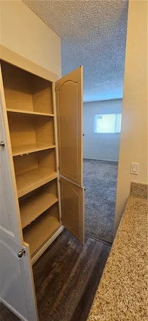 a view of walk in closet with empty racks