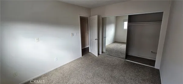 an empty room with closet area