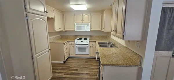 a kitchen with a refrigerator stove and sink