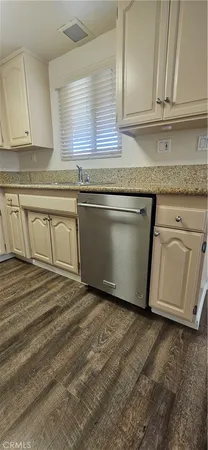 a kitchen with granite countertop a sink and cabinets