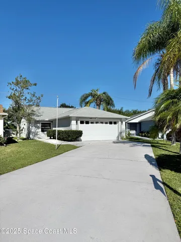 a view of a house with a yard and a car park fire pit