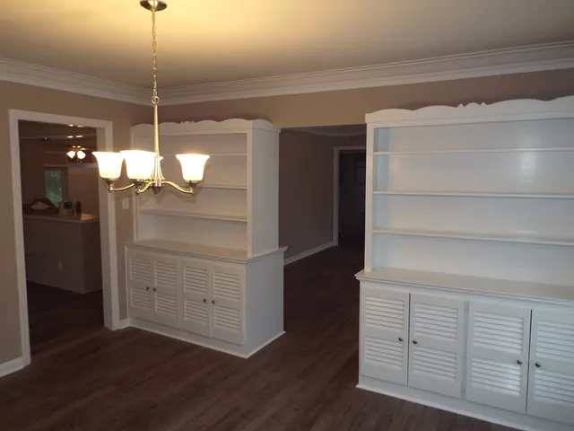 a view of a room with wooden floor