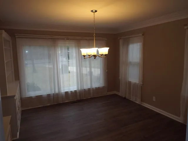 a view of a room with wooden floor and window