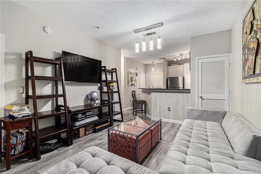 10 Perimeter Summit Boulevard, Unit 4131 Atlanta, GA 30319 - Photo 11 of 30 a living room with furniture and a flat screen tv
